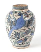 An Iznik / Persian baluster vase, decorated exotic birds and foliage, approx 21cm high.