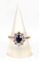 A 9ct gold diamond and sapphire cluster ring, sapphire approx 1.00ct, approx UK size N