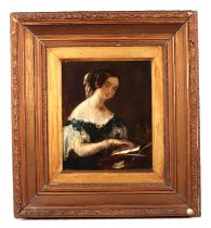 A Victorian school, A bust portrait of a lady at a desk, oil on board, 20 by 25cm, framed.