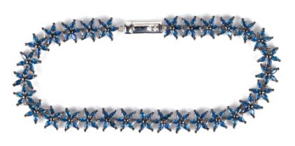 A silver starfish bracelet set with 150 marquise cut blue cubic zirconia.