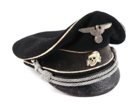 A German peaked cap, together with shoulder epaulettes, aluminium belt buckle, cloth badgers and