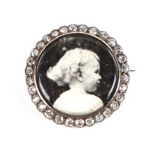 A 19th century yellow metal diamond set mourning brooch, inset a later black and white photograph of