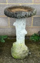 A well weathered stoneware bird bath, 70cm high.