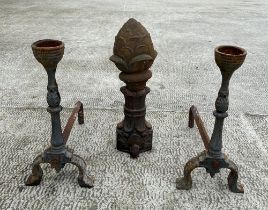 A cast iron pineapple form finial, 54cm high, together with a pair of fire dogs (3).