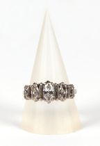 An 18ct white gold and diamond half hoop ring with a central marques cut diamond flanked by
