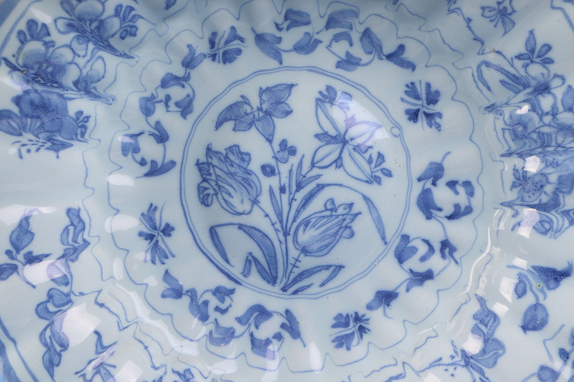 An 18th century Delft tin glaze blue & white fluted rim dish decorated with flowers, 31 cm diameter; - Image 3 of 12