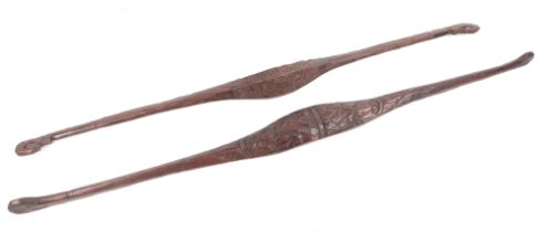 Two carved hardwood shoulder yokes, possibly Indonesian, 135cm and 134cm long (2).