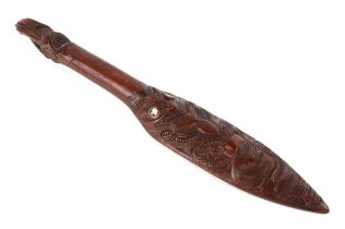 A Maori carved wooden dance paddle, with Tiki inlaid decoration, 48cm long.