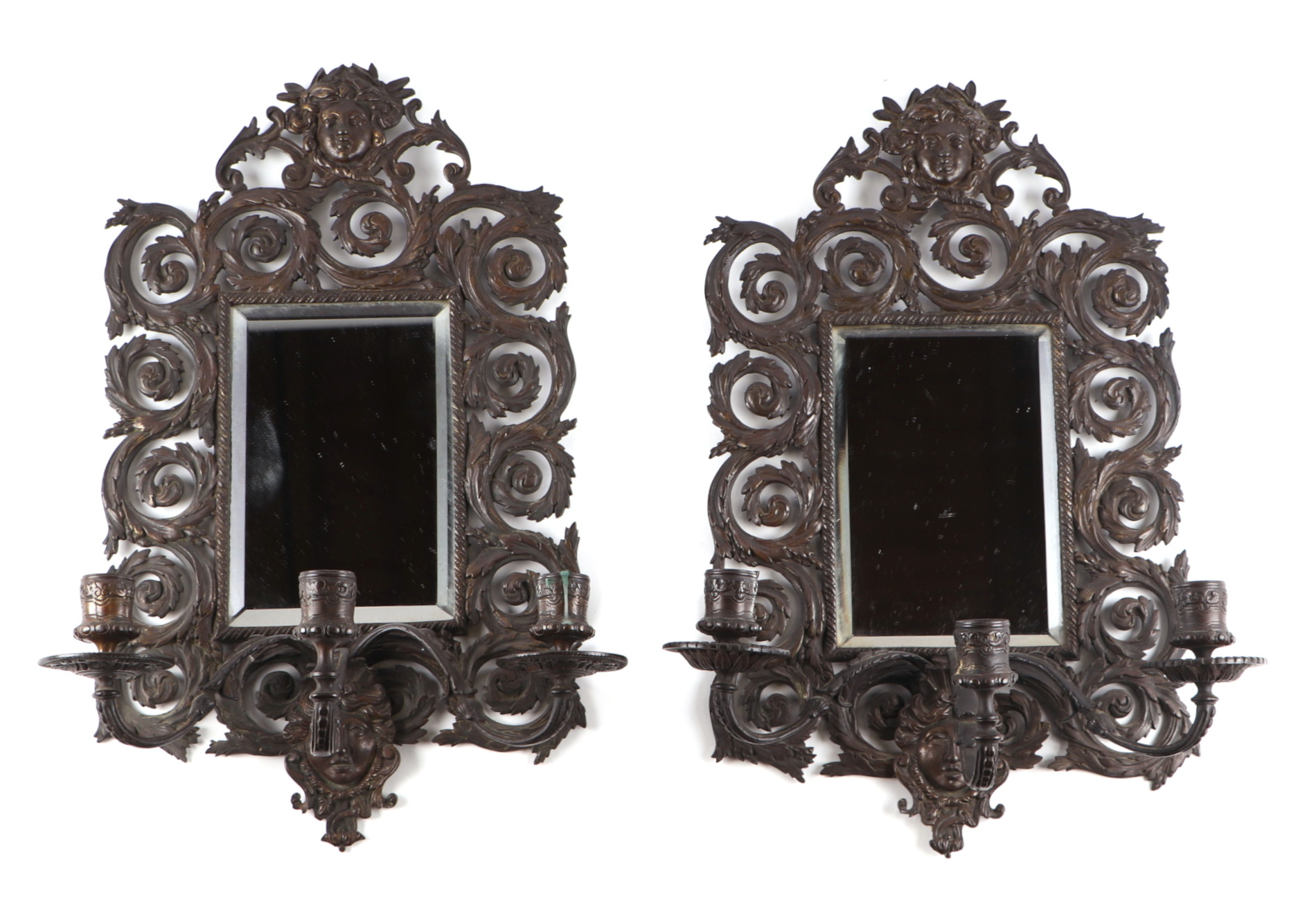 A pair of bronzed mirrored back wall sconces, overall 27 by 44cm.