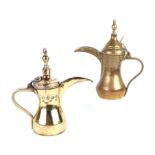 A Turkish / Islamic brass dallah coffee pot, 24cms high; together with another similar, 22cms