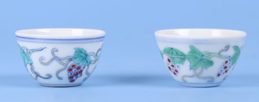 A pair of Chinese Wucai style tea bowls, decorated with grapes and vines, with 6 character blue mark