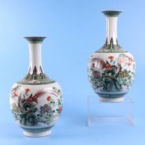 A pair of Chinese famille verte baluster vases, decorated birds and flowering foliage, with six