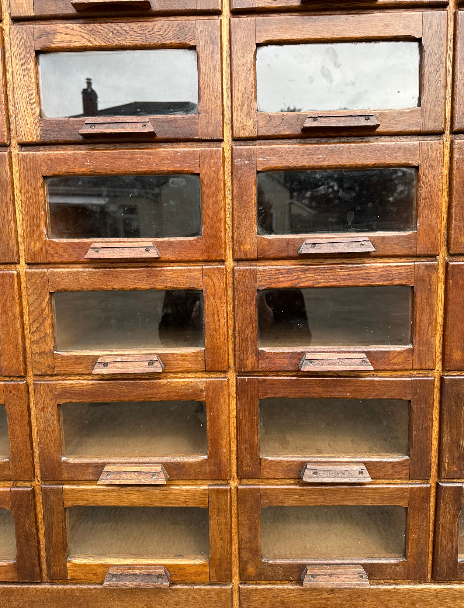 A mid century substantial haberdashery cabinet, with sixty oak fronted glazed drawers, above three - Image 4 of 10