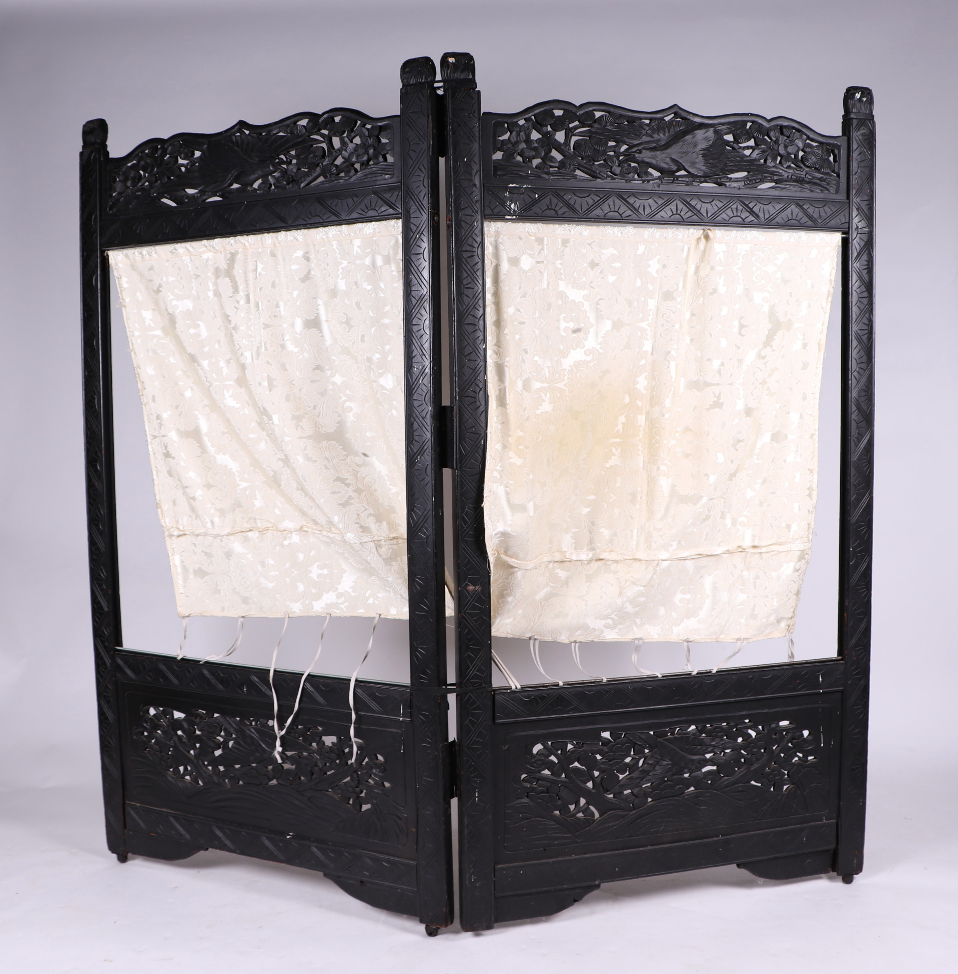 A Japanese ebonised two-fold screen, overall 164 by 152cms high.