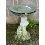 A well weathered stoneware bird bath, 61cm high.