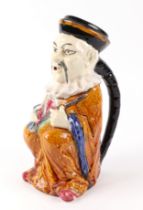 A French pottery water jug, in the form of a seated Oriental gentleman, signed F Perrot and No.395