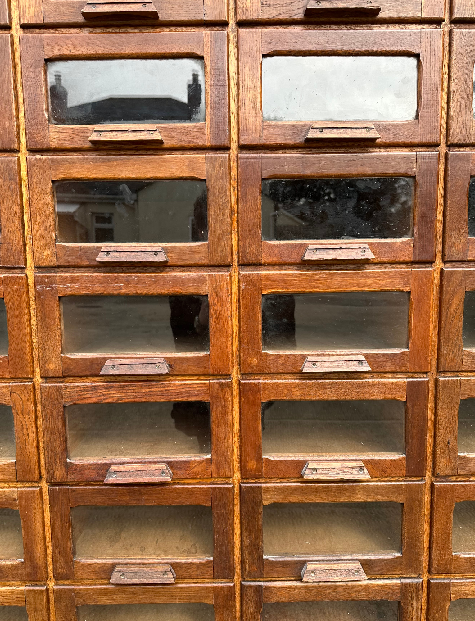 A mid century substantial haberdashery cabinet, with sixty oak fronted glazed drawers, above three - Image 2 of 10