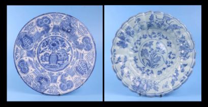 An 18th century Delft tin glaze blue & white fluted rim dish decorated with flowers, 31 cm diameter;