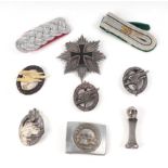A German breast order, belt buckle, SS type desk seal, surmounted a scull, badges and epaulettes.