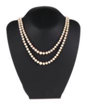An Edwardian double row pearl choker necklace, with 9ct gold garnet and pearl mounted clasp, 46cm