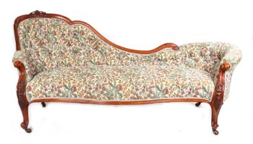 A Victorian upholstered walnut chaise lounge, with carved show wood and dwarf cabriole legs, on