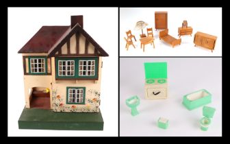 A 1930s Tri-Ang doll's house with a selection of doll's house furniture, 36cm wide.