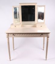 A distressed painted dressing table, with triple mirror, two jewellery drawers, and one frieze