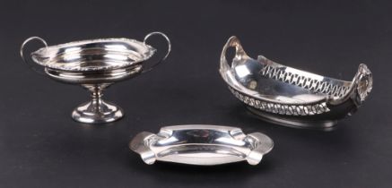 A George V silver pierced basket, Birmingham 1933, 126g, a George V loaded silver two handled bon-