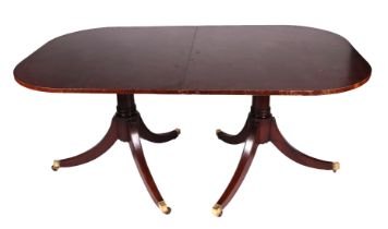 A George III style twin pedestal mahogany dining table.