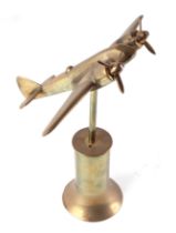 A trench art cast brass model of a Sterling bomber, mounted on a brass plinth, wingspan 23cm.
