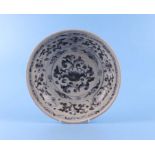 A Vietnamese Anamese blue and white shallow pottery bowl decorated with flowers, 26cm diameter.