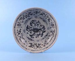 A Vietnamese Anamese blue and white shallow pottery bowl decorated with flowers, 26cm diameter.
