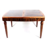 A 1920s Art Deco coromandel dining table, having a rectangular top inset, one extra leaf, on