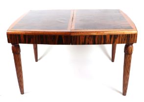 A 1920s Art Deco coromandel dining table, having a rectangular top inset, one extra leaf, on