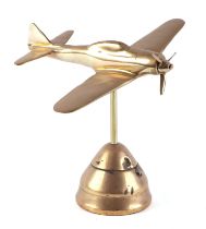 A trench art brass cast model of a Zero aircraft, mounted on a brass fuse, wingspan 23cm.