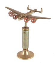 A trench art brass cast model of Wellington bomber, mounted on a brass plinth, wingspan 20cm.