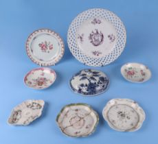 An 18th century Chinese porcelain plate, decorated with an armorial, 24cm diameter, a shaped spoon
