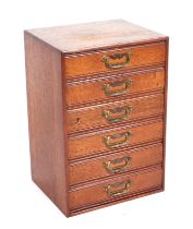 A late Victorian / Edwardian oak table top Collectors Cabinet with a bank of six drawers, Henry