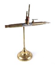 A trench art cast brass model of a Submarine crafted from a brass bullet, mounted on a brass plinth,