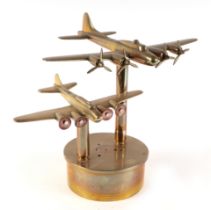 A trench art brass pair of Flying Fortress bombers, mounted on a brass artillery shell base,
