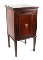 A 19th century mahogany cupboard, having a panelled door, with lion mask handle, opening to reveal a