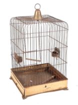 A vintage painted metal parrot cage, with swing and feeders, 70cm high.