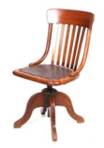 An early 20th century oak swivel desk chair, with slatted back.