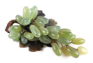 A Chinese moss agate and green hard stone decoration in the form of a bunch of grapes.