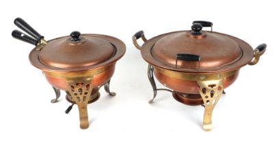 Two copper pans on brass stands with burners, largest 33cm diameter.