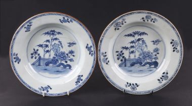 A pair of Chinese blue and white under glazed blue bowls, decorated landscape with bridges and