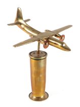 A cast brass model of a twin engine aircraft, mounted on a brass plinth, wingspan 17cm.
