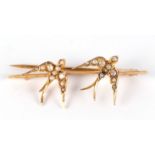 A late Victorian 9ct gold seed pearl set swallow bar cases,4cm wide, 2.4g. Condition Report Two