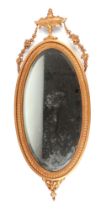 A gilt framed Adams style oval wall mirror, overall 79cm high.