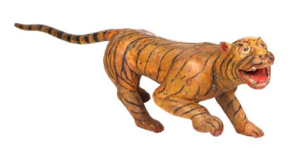 A Burmese carved and painted hardwood tiger (temple guardian), 134cm long.